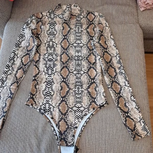 Bodysuit - This is a tiger bodysuit that is in size S and used only 1 time. It looks 1000% new. 