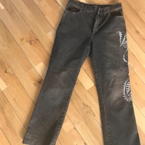 Broderade jeans - Säljer dessa ”bruna” vintage jeans med broderlig längs en benet. Köpta second hand men passade tyvärr inte mig i smaken. Bra längd för 165-168 ungefär. 