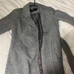 Grå Kappa - Grå kappa från Vero Moda men köpt på Sellpy för 120kr. Använts få gånger o är i bra skick🤭 Säljs pga inge mer användning av det samt inte min stil. 😔😍 Annars är den fin och härlig🙌 Vill bli av med den, ni kan få klädhängaren på köpet om ni vill⭐️❗️