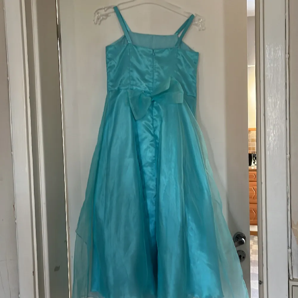 Säljer denna jätte fina klänning då jag har använt den 1 gång. På ett bröllop ungefär 2018. Den är nu förliten för mig och kommer därför inte till användning. Den har tappat en berlock men inget som man märker av. (Se bild). Klänningar.
