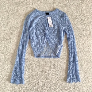 Ginatricot ljusblå spetstopp - Otroligt fin ljusblå spetstopp med långa ärmar från Ginatricot. Storlek M. Ny med tags kvar, utan anmärkningar.