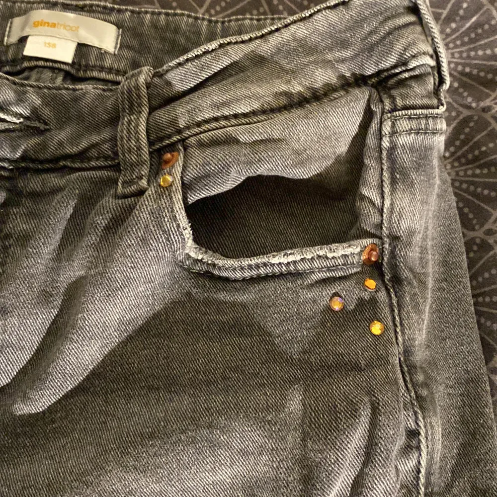 Gråa now waist bootcut jeans från Gina Tricot i storlek 158 med kristall detaljer på fickorna . Jeans & Byxor.