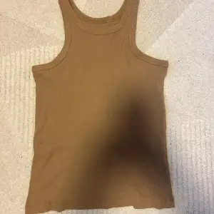 Ett brunt ribbad linne i storlek XS, den är knappt använd. 
