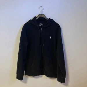 Ralph Lauren Zip Hoodie  - Trendig Ralph Lauren zip hoodie i nyskick! Knappt använd Ralph Laurien hoodie. Exakt som ny! Storlek L men passar lika bra till M. Inga defekter eller slitage alls! Vid flera funderingar hör gärna av er i DM!😃