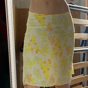 Kjol -  Jättesöt gul silk kjol med blommor/växter som har jätte skönt material ! Det finns en dragkedja på sidan. Perfekt till våren och sommaren och sitter jättefint💗 köpt i Spanien och helt oanvänd! 