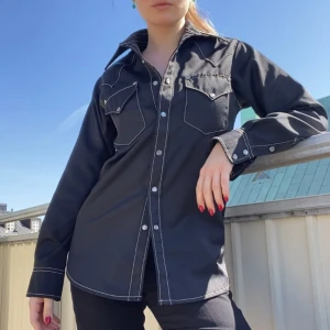 Svart unisex skjorta/overshirt/jacka från Eytys - Världens coolaste unisex skjorta/overshirt/jacka från Eytys i modellen “Sierra Cali”. Plagget går att använda som en skjorta, overshirt, eller jacka. Storleken är XS, men passar även S bra. Mycket bra skick. Nypris runt 2500kr. 