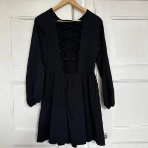 Jättefin svart klänning med snörning i ryggen, använd endast 1 gång!