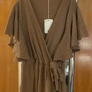 Säljer en brun oanvänd långklänning passar en S/ M Måste vara kanske 170 cm. Lång klänning