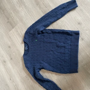 Ralph Lauren tröja  - Ralph lauren stickad tröja i storlek 14-15 år. Fint skick. Marinblå och grönt märke. Kan prutas