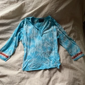 Blå tröja med kantband - Fin tröja från kaffe med tiedye tyg och mönstrade band på ärmarna. Storlek L men skulle säga snarare M. Hör av dig vid frågor ☺️