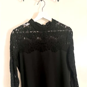 Svart klänning med spets - Fin, svart klänning med spets! Långärmad och är ungefär till knäna.
