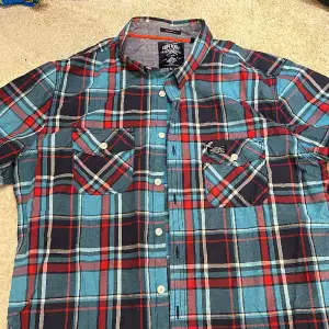 Rich blue and red checks, excellent condition, worn sparingly. Ideal for a casual, smart look