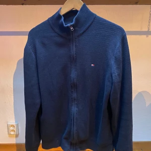 Tommy Hilfiger zip - En snygg och skön fullzip från Tommy Hilfiger. Används ett fåtal gånger och väl omhändertagen! Hör av dig vid minsta lilla fundering!
