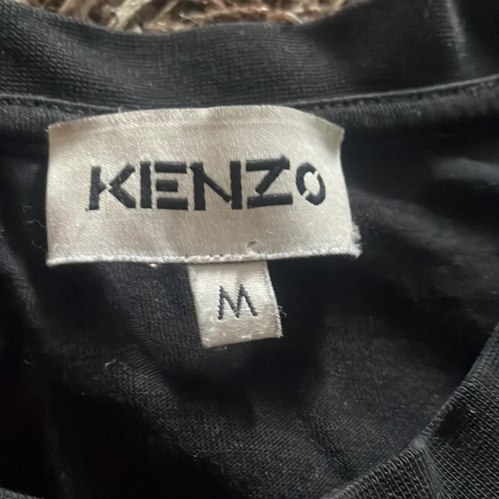 Säljer denna Kenzo tröjan som inte säljs längre med en mocka logotyp som är använt ett par gånger för länge sedan som är perfekt inför sommaren .Nypris 1500kr. Skick 8/10. PRISET KAN DISKUTERAS!!. T-shirts.