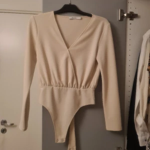 Beige body - Otroligt fin beige body som inte kommer till användning. Har använt den en gång, är i storlek S. Super fin och skönt material är från NA-KD. Köparen står för frakten. Skriv vid frågor💕