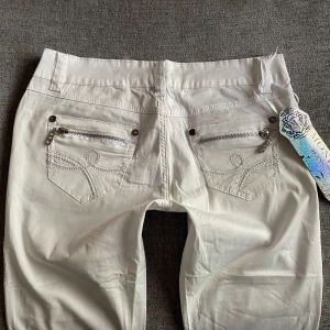 Vita Lågmidjade  - Snygga (typ straight) Lågmidjade byxor i lent material med lapp kvar💕 Storlek 38, men passar mer folk med 34-36! Innerbenslängd 82 midjemått 37. Har tyvärr ingen bild på då dem inte passar.❤️