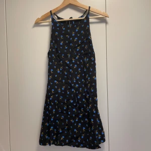 Sommarklänning - Kort klänning från Bershka! Säljer då den är för liten. Fint skick🌟 Svart med blå blommor på💙 Storlek 36