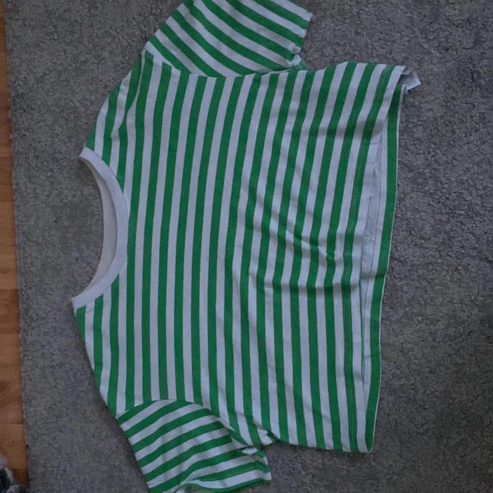 A green and white striped t shirt, short, only used a few times, good condition . T-shirts.