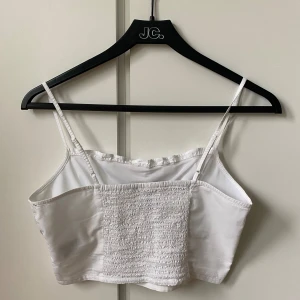 Vit topp - Superfin topp från H&M, stretchig bak och har justerbara axelband, strl 36, oanvänd!