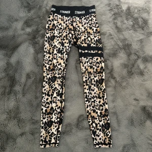 Stronger Byxor - Dessa är köpta från hemsidan stronger, och byxorna har leopard design, med 2 svarta ränder på ett ben. Stl XS, bra skick