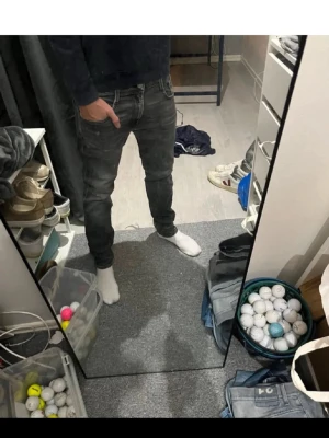 Svarta slim fit jeans herr Replay  - Säljer ett par svarta slim fit jeans med klassisk femficksdesign och snygga slitningar. Jeansen har normal midja och smal passform hela vägen ner. Perfekta för en avslappnad men ändå stilren look. Nackdel hål i röven 