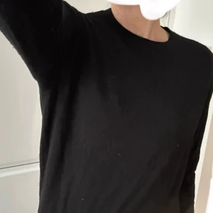 Klassisk mjuk finstickad ulltröja - Mjuk och behaglig tröja klassisk modell i 100 % mjuk ull.   Fint skick. Svart. Personen på bilden är 172 cm lång och brukar använda L