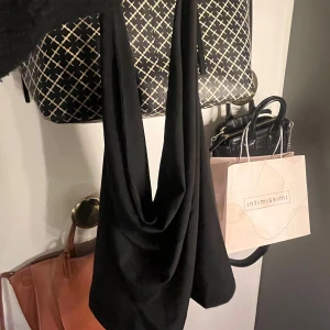 Halterneck topp  - Jättefint helt ny halterneck topp från bikbok. Toppen har en fin vattenfalls urringning med öppen rygg. Perfekt topp för fest eller middag! Säljer pga att modellen på topp inte passar mig 