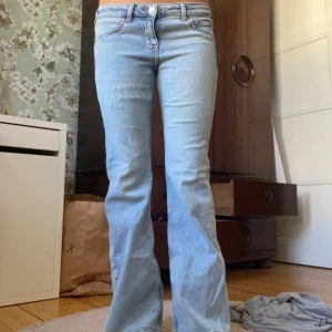 Ljusblå bootcut jeans - Säljer dessa ljusblå lågmidjade utsvängda jeans, i bra skick! Har sprättat upp de längst ner vilket syns på bild tre. Det står storlek 38 men passar mig som brukar ha S i byxor 🥰