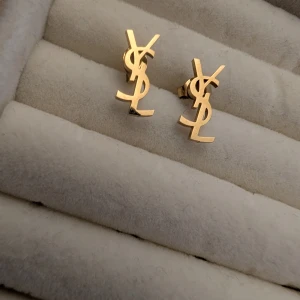 Guldiga örhängen  - Har både av YSL och CC , helt nya och oanvända. 100 kr/par