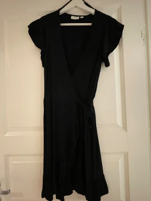 Svart omlottklänning - Söt svart omlottklänning från märket VILA