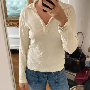 Vit pikétröja från Filippa K - Klassisk vit pikétröja från Filippa K med lång ärm och krage. Tröjan har knappar framtill och är tillverkad i mjuk bomull. Perfekt basic med clean look och snygg passform. Strl M men passar mig som är XS i vanliga fall.