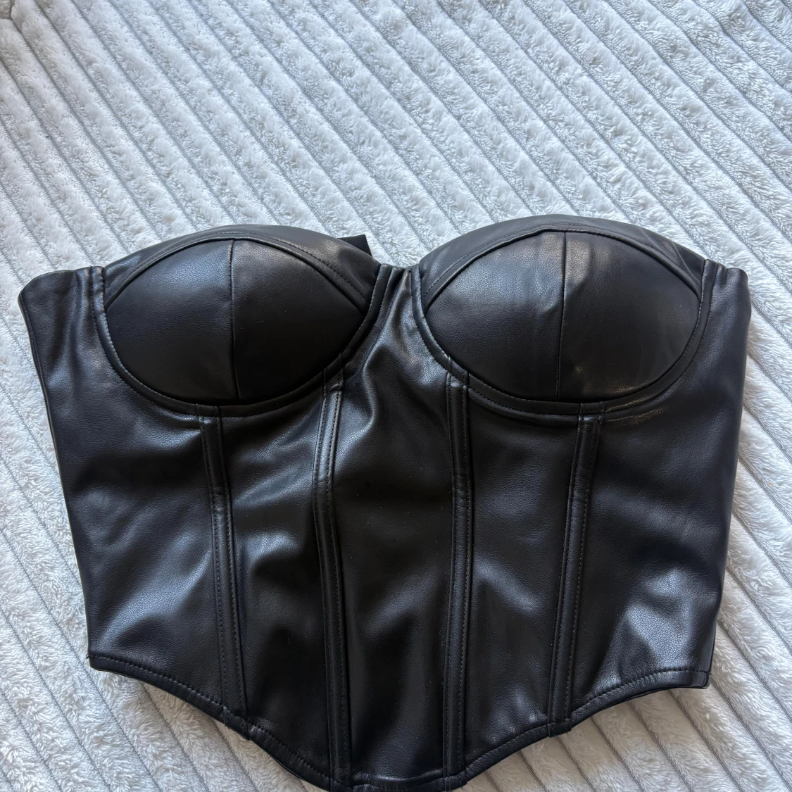 Svart skinnkorsett med kupor