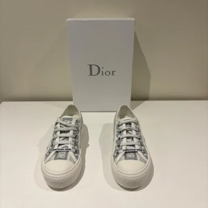 Dior skor - Säljer ett par snygga Dior-sneakers i klassisk grå/vit monogram-design.  Storlek: 37  Skick: Mycket bra, endast använda 1-2 gånger  Skor och originalkartong medföljer.  Kvitto finns!  Perfekta till både vardag och fest för dig som gillar exklusiva märken.  💌 Skicka gärna meddelande vid frågor eller om du vill ha fler bilder.