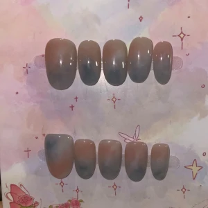 S - naglar i beige och blågrå ombre - Snygga lösnaglar i en oval form med en trendig ombre-effekt i beige och blågrå toner. Naglarna har en glansig finish och passar perfekt för dig som vill ha en stilren men ändå unik look. Kommer i set om tio naglar i olika storlekar.