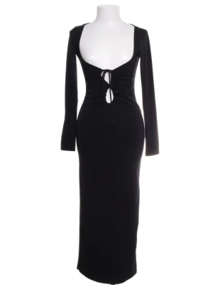 Svart långklänning med snörning - Snygg svart långklänning med djup v-ringning och snörning framtill. Klänningen har långärmade ärmar och en kroppsnära passform som framhäver siluetten. Materialet är mjukt och stretchigt. 