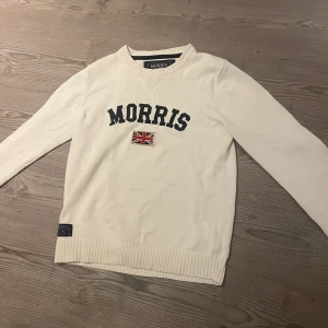 Morris tröja  - Snygg vit Morris tröja med mörkblå text och en broderad brittisk flagga på bröstet, riktigt fräsh! Skriv vid funderingar 