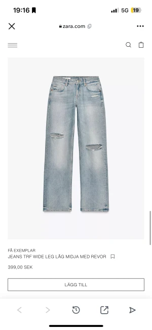 zara baggy lågmidjade jeans - Snygga ljusblå jeans med låg midja och extra vida ben från Zara. Modellen har fem fickor och slitna detaljer med revor på knäna. Klassisk jeansknäppning med dragkedja och knapp framtill. Perfekt för en avslappnad streetstil.