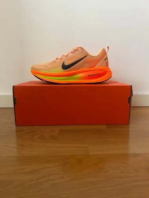 Nike Vomero 18, Orange, EUR 41 - Nike Vomero 18 - helt nya (41) - Perfekt julklapp Oanvända Nike Vomero 18 i en skarp orange färg. Lätt, mjuk och stabil löparsko med riktigt bra dämpning. Kommer självklart i originalkartong.  • Oanvända • Originalkartong • Premiumkomfort • Perfekt julklapp  Snabb affär - först till kvarn!