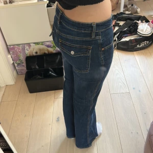 Mörkblå bootcut jeans från Lager 157 - Snygga mörkblå jeans från Lager 157 med bootcut passform. Klassisk femficksdesign med extra ficklock bak och kontrastsömmar. Jeansen har normalhög midja och är gjorda i mjukt denimtyg som sitter skönt hela dagen.