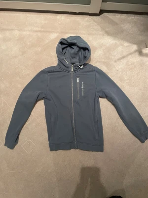 Sail racing zip hoodie - Grå/blå sail racing hoodie med dragkedja. Hoodien är i bra skick och äkta. Skicka gärna om ni har frågor eller prisförslag! Storleken är 160 som motsvarar 160cm ungefär