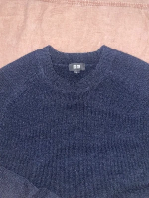 Mörkblå Stickad Tröja - Snygg stickad tröja från uniqlo i storlek S. Tröjan är endast använd ca 5 ggr. Skriv gärna vid funderingar.