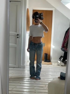 Low waist jeans från brandy Melville  - Säljer ett par klassiska blå jeans med bootcut-snitt och låg midja. Jeansen har en lätt tvättad look och raka ben som blir lite vidare nedtill. Materialet är jeans och passformen är loose, perfekt för en chill och avslappnad stil.