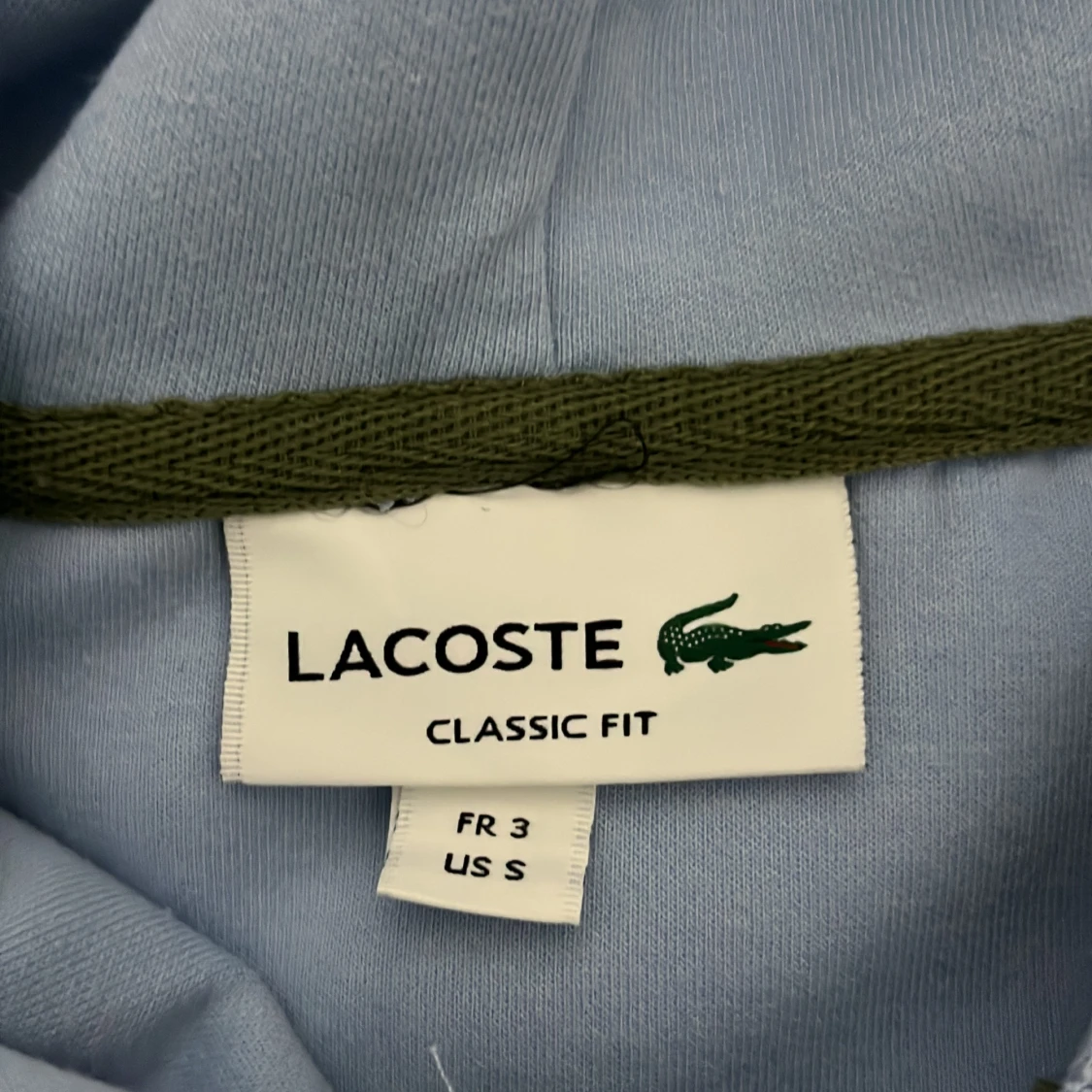 Ljusblå hoodie från Lacoste - 1