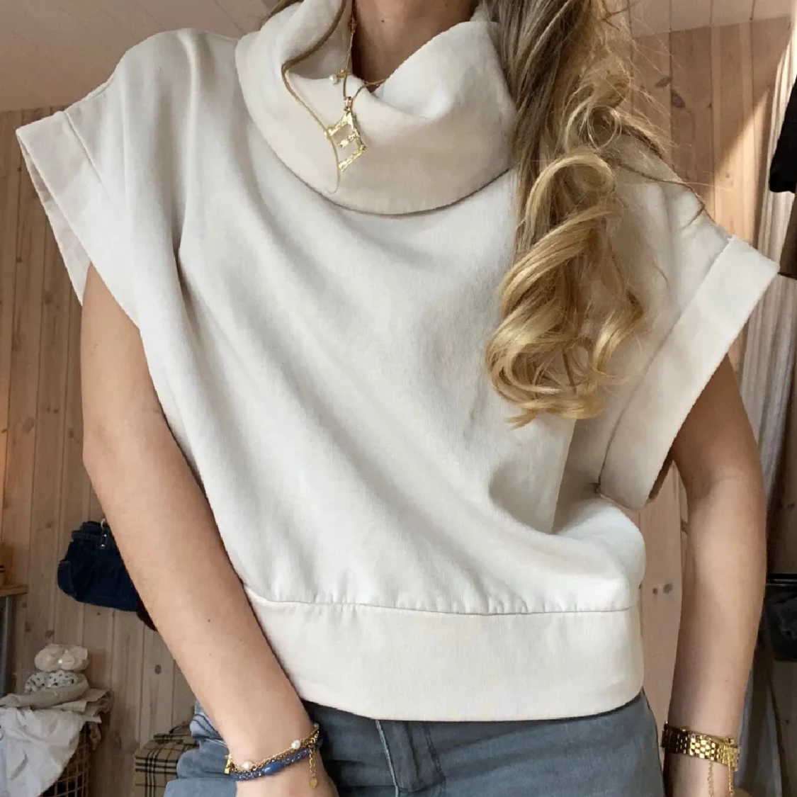 Beige ärmlös tröja med hög krage