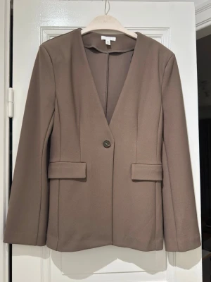 Blazer from H&M in S size  - Never used blazer from H&M in S size and Khakee green color.  It has 1 button infront and pockets flap for detail. Well tailored and thick material. It has shoulder padding for a good structure.   Please check my other listing to get bundle offer!