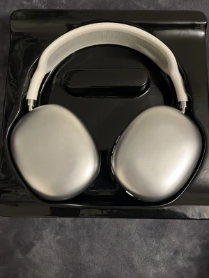 Apple liknande hörlurar - Säljer ett par hörlurar i silver med en clean och modern design. Hörlurarna har stora ovala kåpor i aluminium och mjuka mesh-kuddar för extra komfort. Bygeln är vit och vadderad med mesh-tyg. Perfekta för dig som vill ha grymt ljud och snygg stil. Pris kan diskuteras.