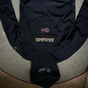Mörkblå jacka / anorak  från Napapijri - Den är inte använd mycket alls och är ett fint skick. Nypriset ligger på 2899. Om du har frågor är det bara att skriva!:)