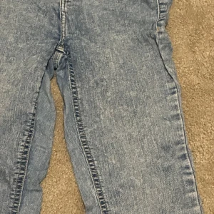 Blå bootcut jeans från H&M - Snygga ljusblå bootcut jeans med klassisk femficksdesign och dragkedja. Jeansen har en något utsvängd passform nertill och är tillverkade i mjukt denimtyg. Perfekta för dig som gillar en retroinspirerad look.