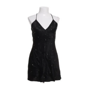 Svart klänning Zara - Supersnygg svart kort klänning från Zara med tunna axelband och v-ringning. Klänningen har små silvriga detaljer över hela tyget och är tillverkad i ett glansigt material som ger en lyxig känsla. Storlek M, men passar även xs/s! Perfekt för tex fest eller middagar! Köp direkt för 99kr via köp nu💞😍