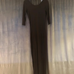Svart långklänning från Zara - Använt ett fåtal gånger. Svart långklänning från Zara med trekvartsärm och djup v-ringning i ryggen. Klänningen har en slits på sidan och är figurnära i modellen. Tillverkad i mjuk bomullsmix som känns skön mot huden. Perfekt för dig som gillar stilrena och enkla plagg med en twist.